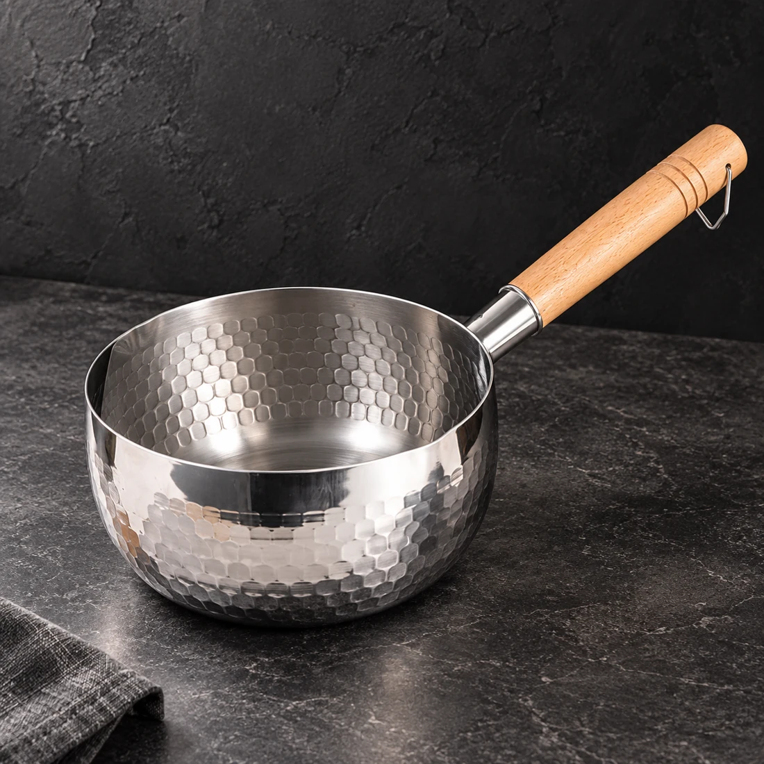 Hammered silver-tone saucepan with a wooden handle